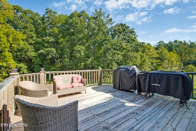 wooden deck featuring a grill