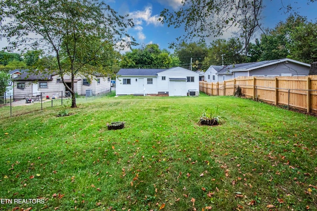 view of yard featuring central AC and an outdoor fire pit