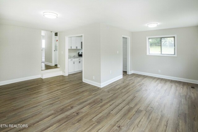 spare room with hardwood / wood-style floors