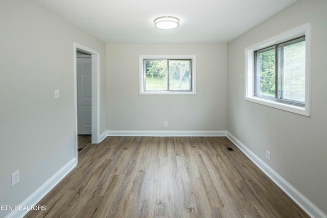 empty room with hardwood / wood-style floors