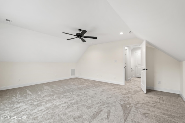 bonus room with lofted ceiling, ceiling fan, and light colored carpet