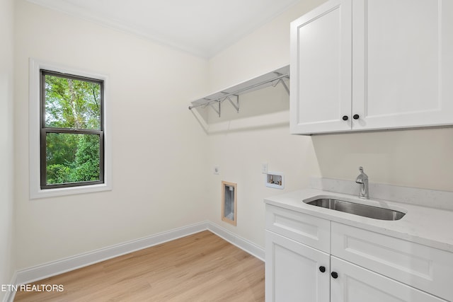 laundry area with cabinets, light wood-type flooring, hookup for an electric dryer, washer hookup, and sink