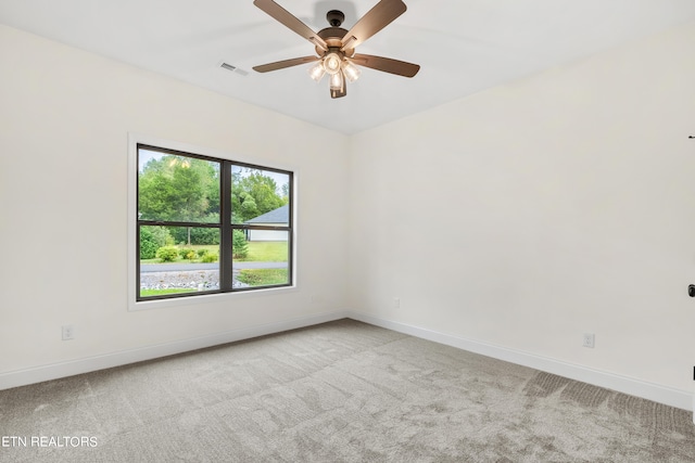 spare room with ceiling fan and light carpet