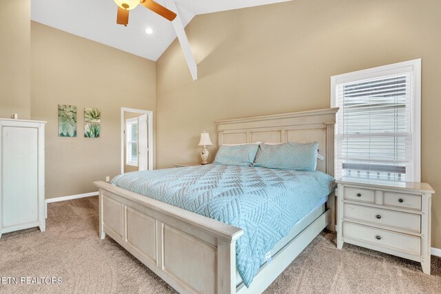 carpeted bedroom featuring multiple windows, ceiling fan, and high vaulted ceiling