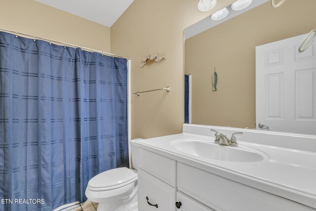 bathroom featuring tile patterned flooring, vanity, toilet, and a shower with curtain