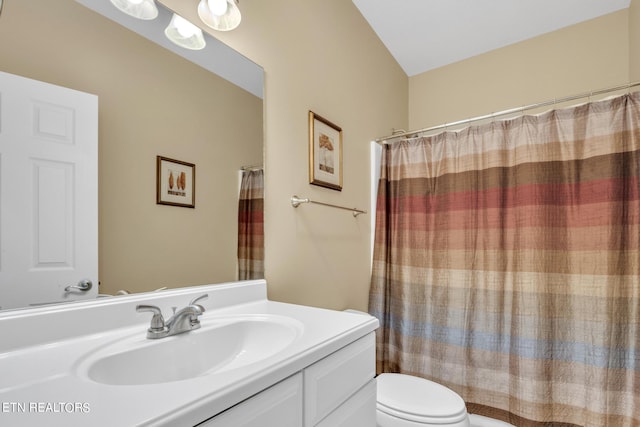 bathroom with a shower with shower curtain, vanity, and toilet