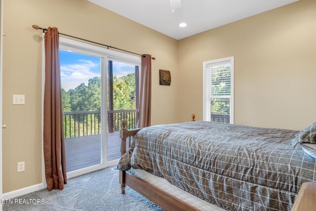 carpeted bedroom with ceiling fan and access to exterior