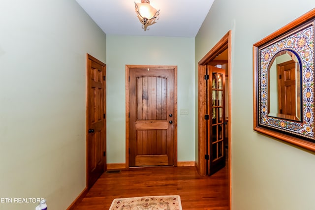 entrance foyer with dark hardwood / wood-style floors