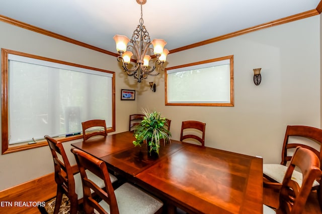 dining area featuring ornamental molding, an inviting chandelier, and wood-type flooring