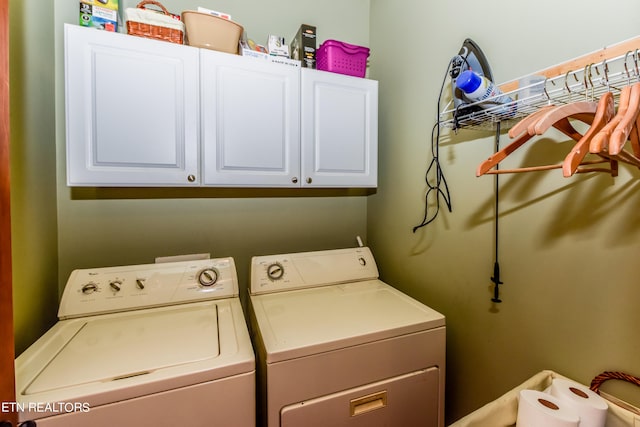 laundry room with washer and clothes dryer and cabinets