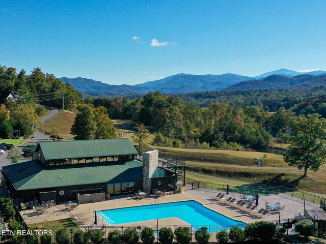 view of swimming pool featuring a mountain view and a patio