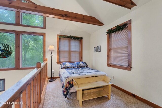 carpeted bedroom featuring vaulted ceiling with beams