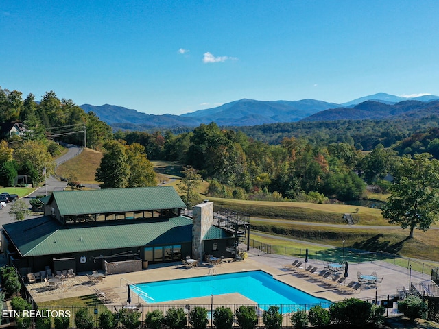 view of swimming pool featuring a mountain view and a patio area