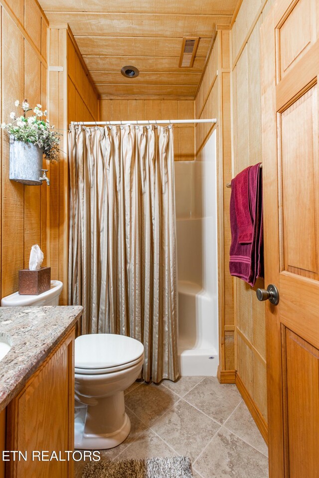 bathroom with wood ceiling, wood walls, toilet, and a shower with shower curtain