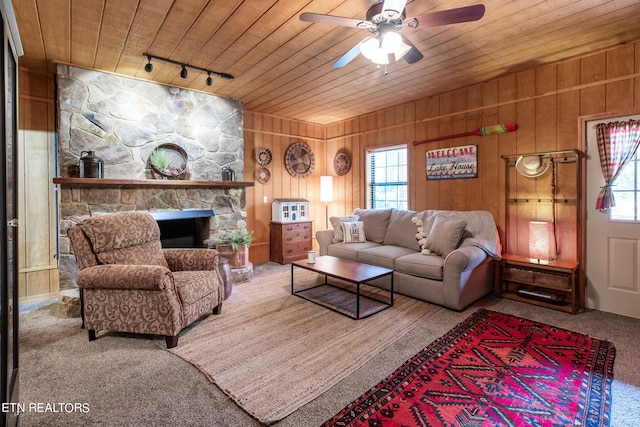 carpeted living room featuring wooden ceiling, rail lighting, ceiling fan, and plenty of natural light