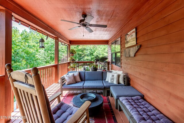 deck with outdoor lounge area and ceiling fan