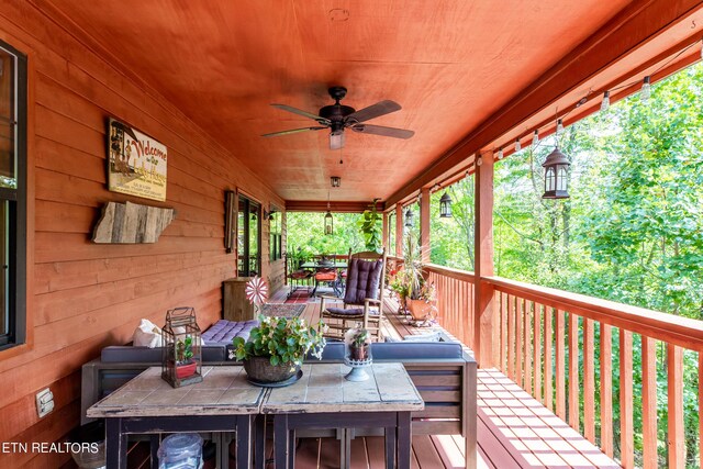 wooden terrace featuring ceiling fan