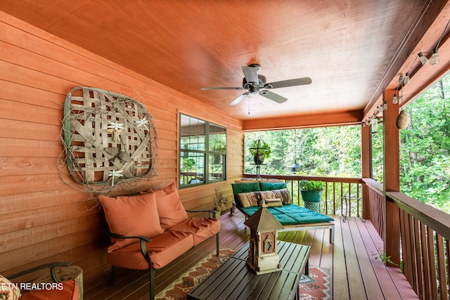 wooden terrace featuring ceiling fan and an outdoor hangout area