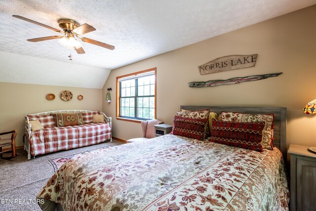 carpeted bedroom with a textured ceiling, lofted ceiling, and ceiling fan