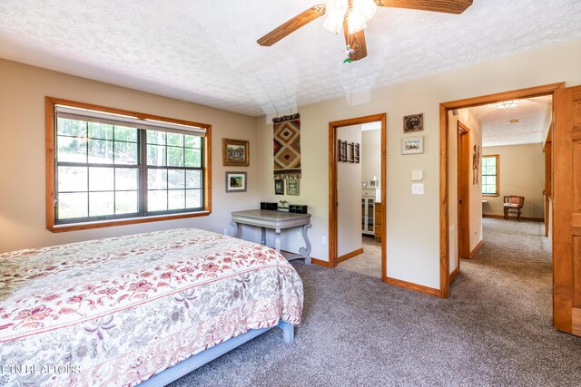 bedroom with a textured ceiling, ceiling fan, and carpet floors