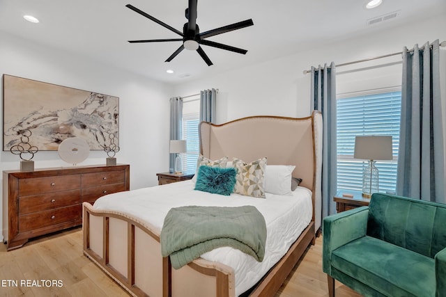 bedroom with ceiling fan and light hardwood / wood-style flooring