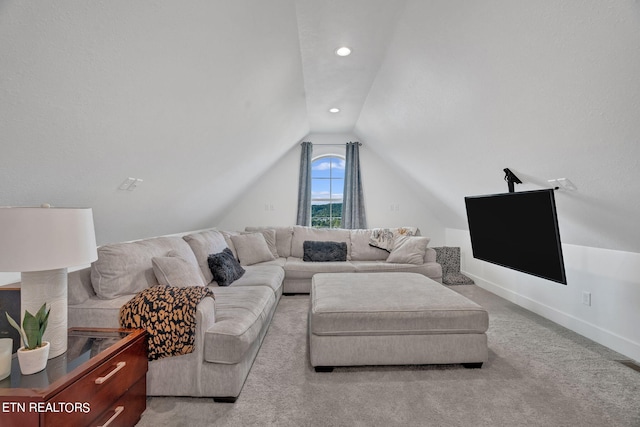 carpeted living room featuring vaulted ceiling