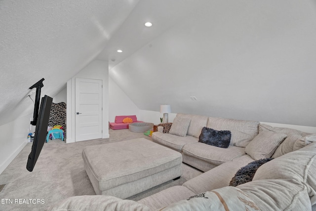 living room with a textured ceiling, light carpet, and vaulted ceiling