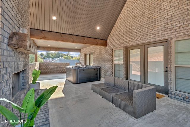 view of patio / terrace with an outdoor living space with a fireplace