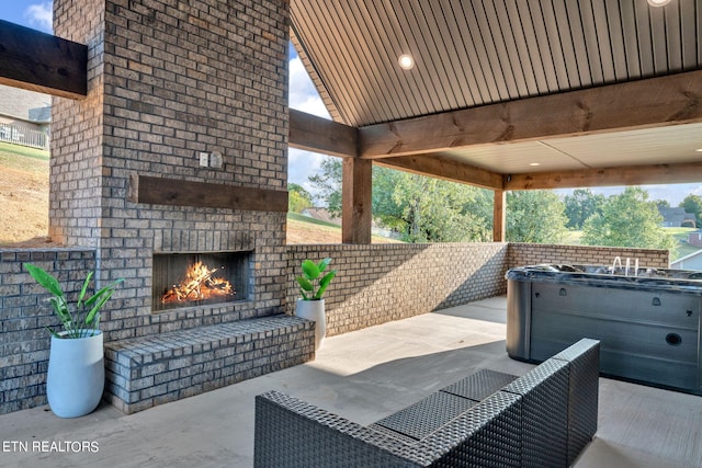 view of patio featuring an outdoor brick fireplace