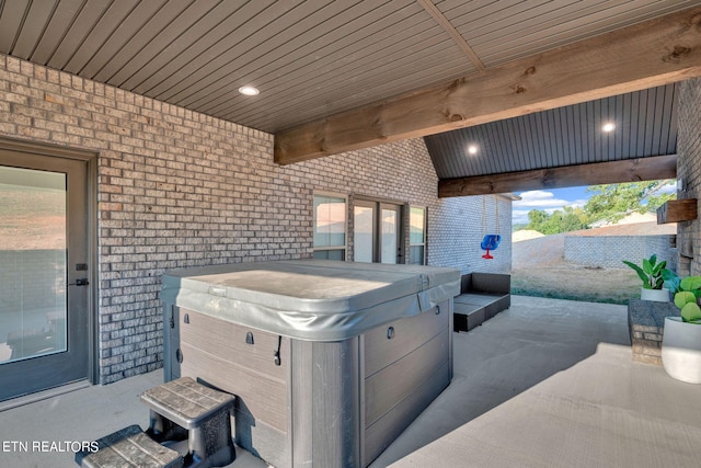 view of patio / terrace with a hot tub