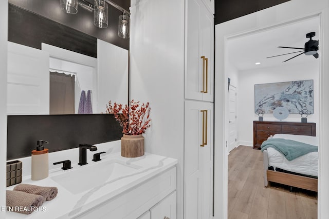 bathroom featuring vanity, ceiling fan, and wood-type flooring