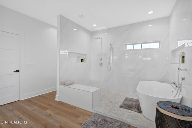 bathroom featuring hardwood / wood-style flooring and independent shower and bath