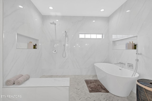 bathroom with a bath and tile walls