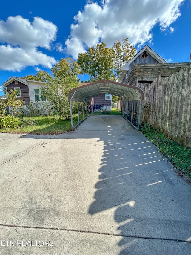 view of parking / parking lot with a carport