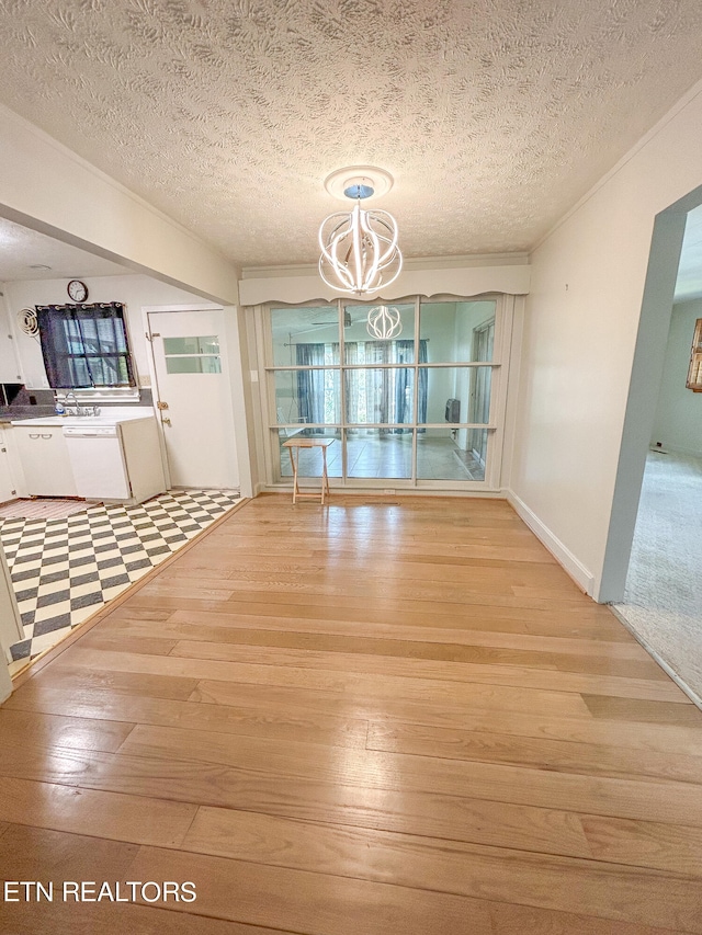 unfurnished dining area with hardwood / wood-style flooring, a textured ceiling, and a chandelier