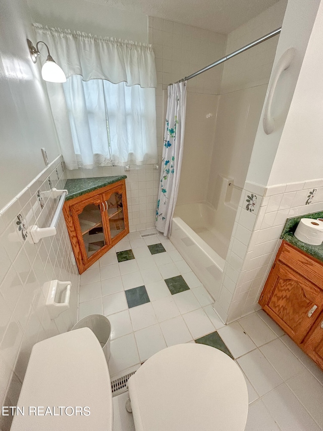 bathroom with toilet, shower / bathtub combination with curtain, and tile walls