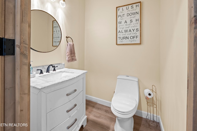 bathroom featuring vanity, toilet, and hardwood / wood-style flooring