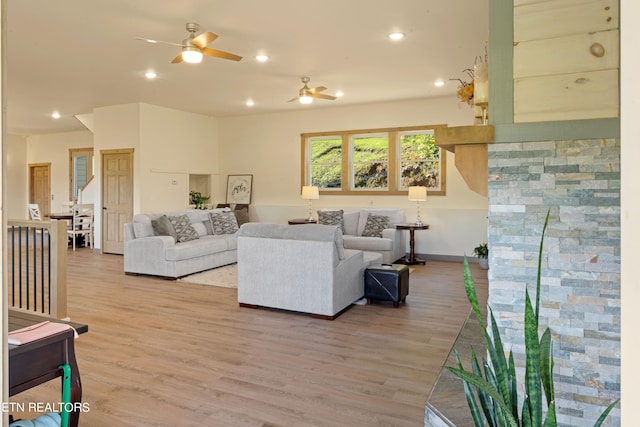 living room with hardwood / wood-style floors and ceiling fan