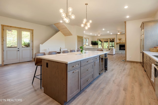 kitchen featuring a healthy amount of sunlight, a breakfast bar area, and pendant lighting