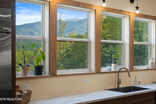 kitchen with stainless steel fridge, sink, and a mountain view