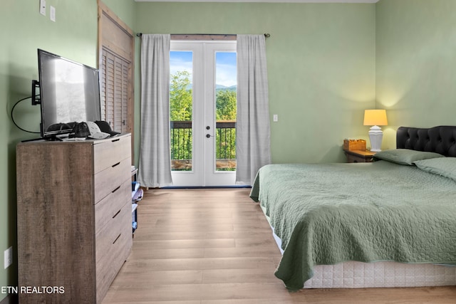 bedroom featuring french doors, access to exterior, and light hardwood / wood-style floors