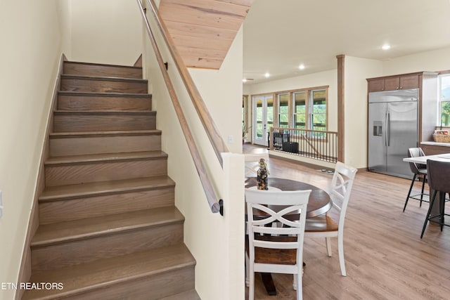 stairs with hardwood / wood-style flooring