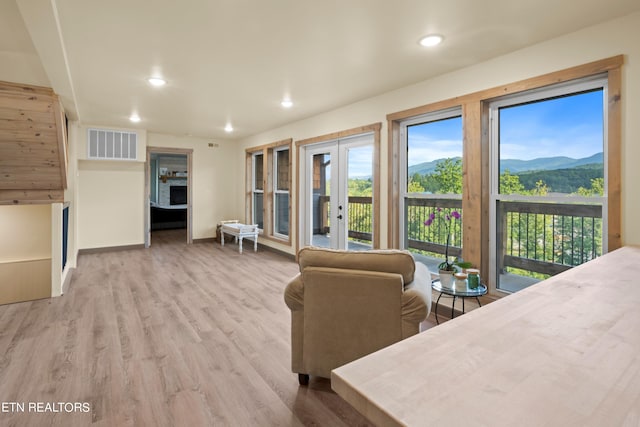 living room featuring light hardwood / wood-style flooring and a mountain view