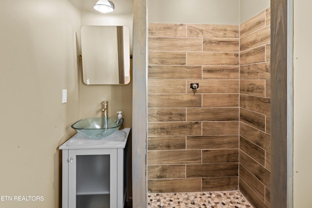 bathroom with a shower and vanity