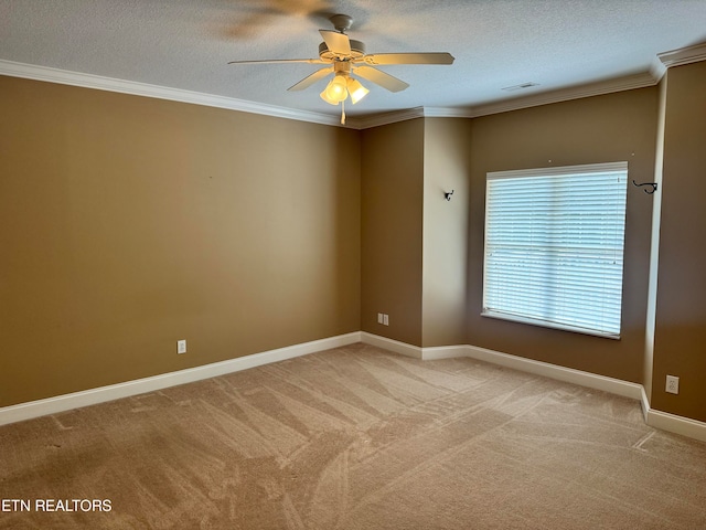 spare room featuring a textured ceiling, light colored carpet, ceiling fan, and crown molding