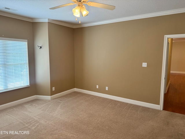 empty room with ceiling fan, ornamental molding, wood-type flooring, and a textured ceiling