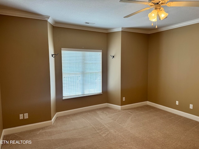 empty room featuring a textured ceiling, crown molding, ceiling fan, and carpet floors