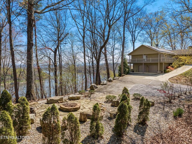 view of yard with a garage and an outdoor fire pit