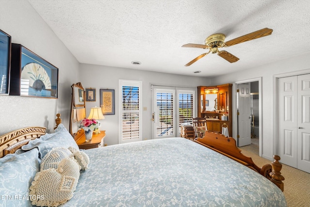 bedroom featuring a textured ceiling, access to exterior, ceiling fan, and carpet