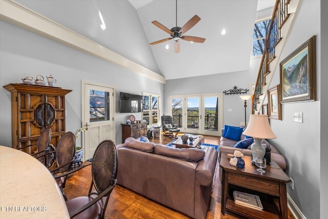 living room featuring ceiling fan, hardwood / wood-style floors, and high vaulted ceiling